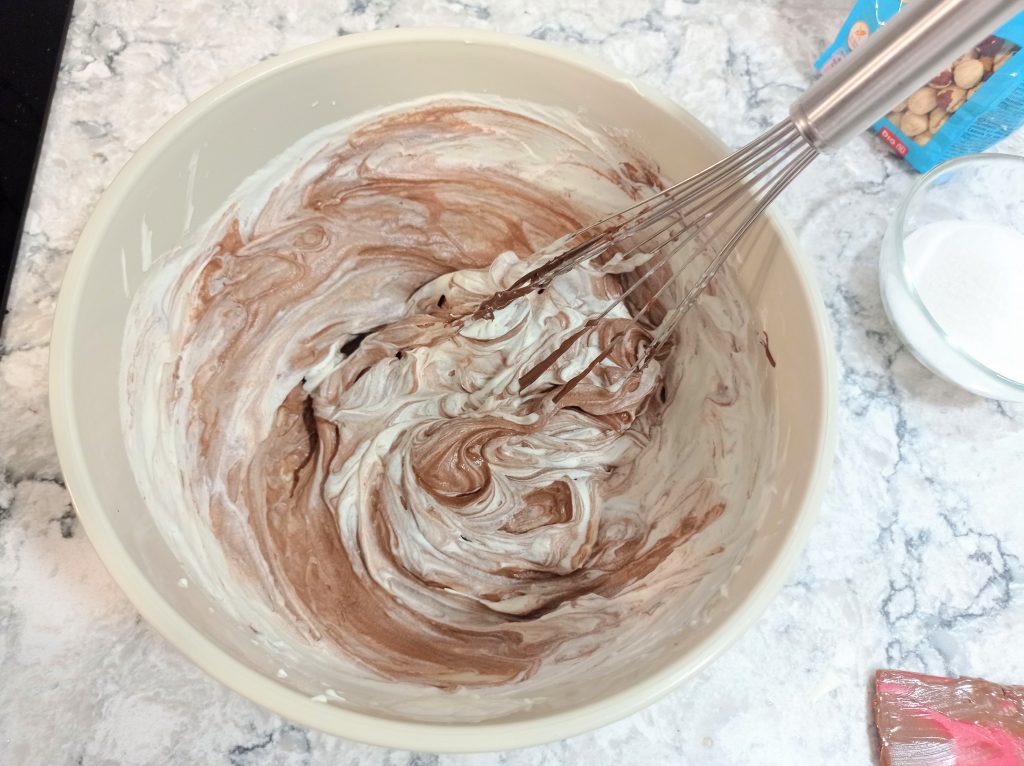 nutella y nata montada mezclando en un tazón mediano